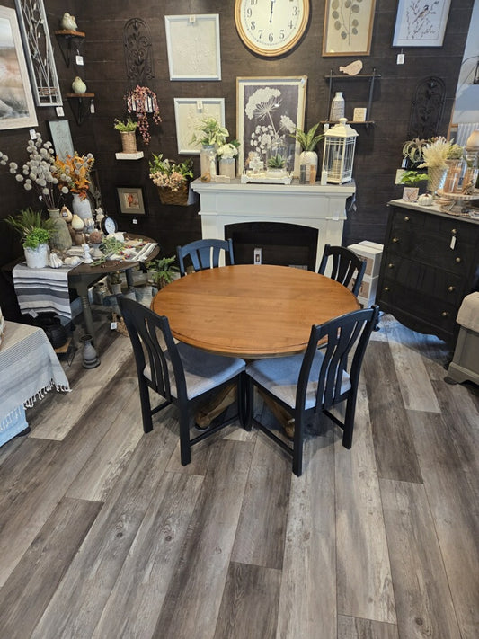 Table and 4 chairs. -47 inches round. 2 10 inch leaves.